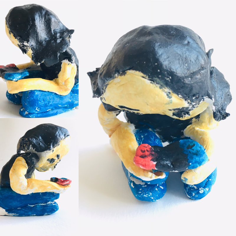 Small self-portrait sculpture of a young girl playing Nintendo