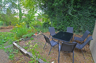 Photo: Open Door garden with table and chairs